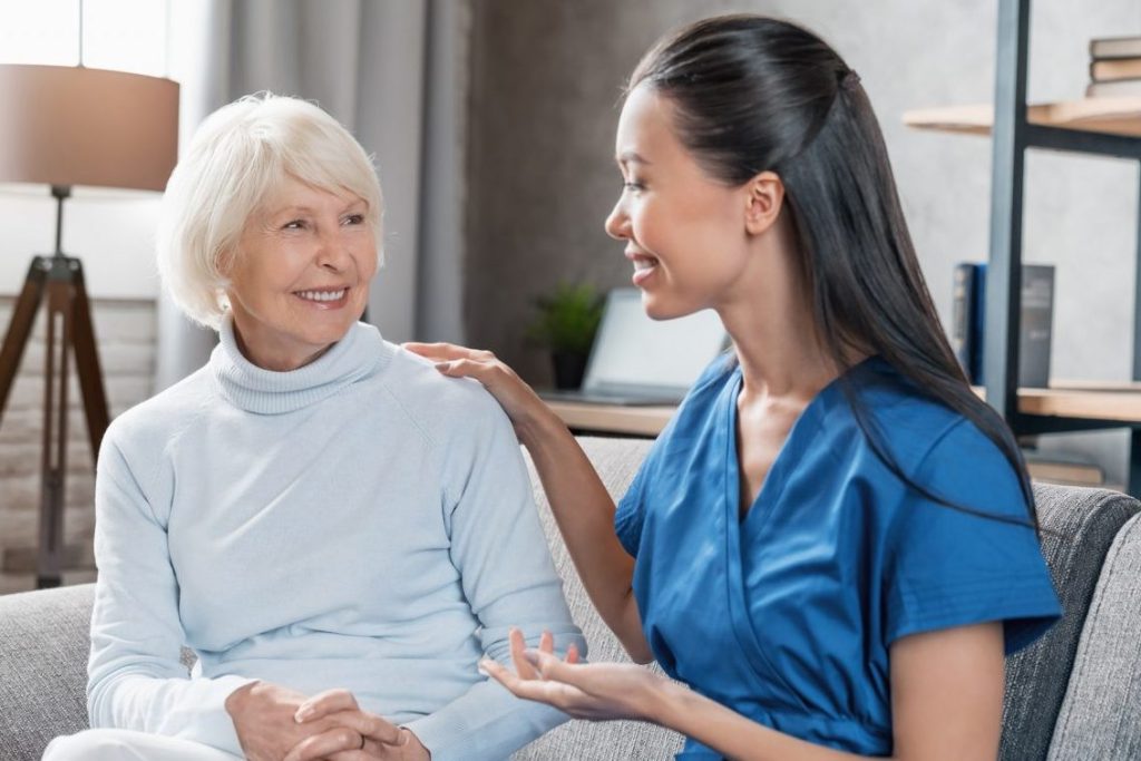 A woman talking to an older person